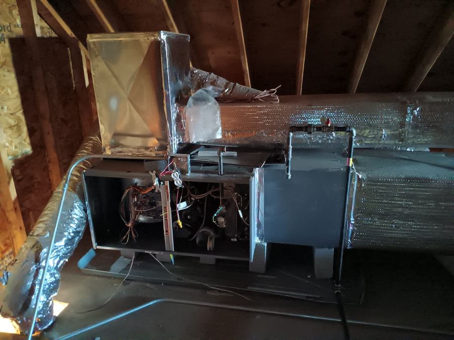 Attic-mounted air handler connected to insulated supply trunk and flex duct