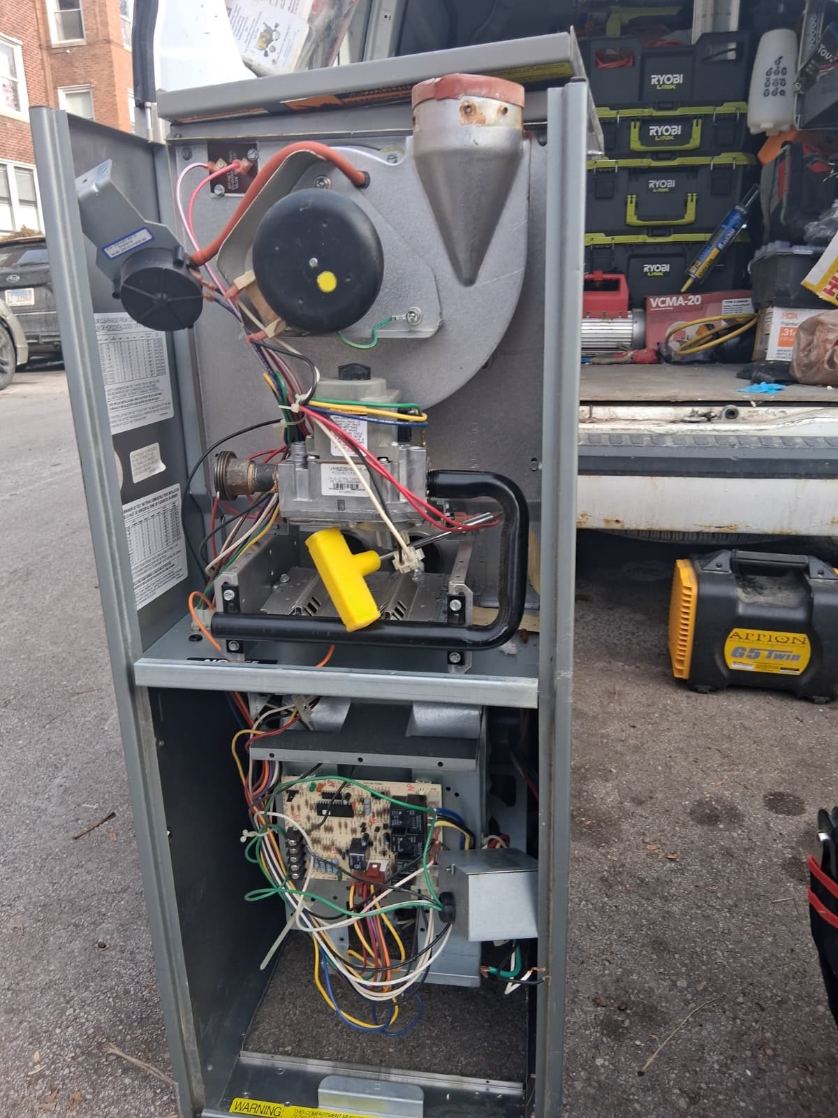 Furnace opened for service showing the blower, gas valve and control board